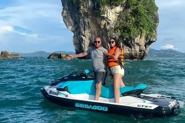 Group riding jet skis on Phuket's vibrant blue ocean, enjoying a sunny day on the water.