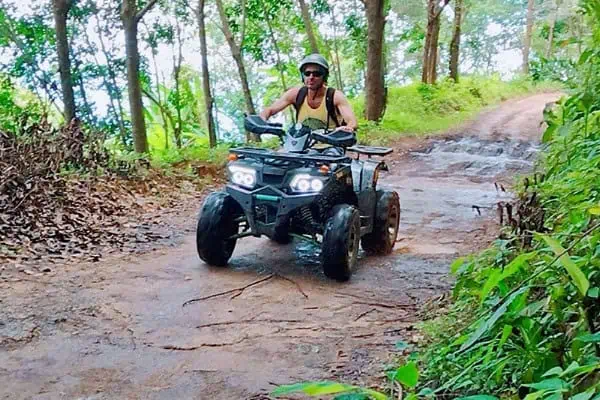 ATV ride through a muddy jungle trail in Phuket, showcasing the thrill of off-road adventure.