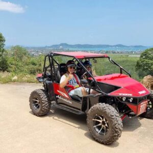 A man and woman enjoy a ride together in a vibrant red UTV, showcasing adventure and companionship in the outdoors.