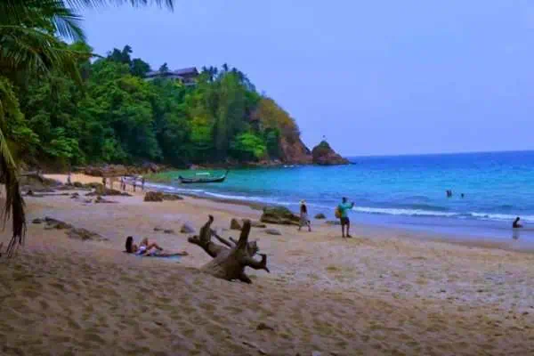 Banana Beach in Phuket with clear water, sandy shores, and lush tropical scenery.