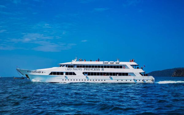 A large white ferry navigates the ocean waters near Ao Nang, Phuket, showcasing a serene maritime scene.