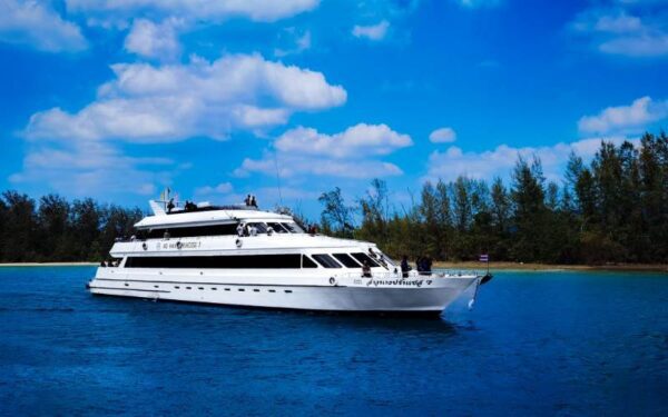 A white ferry traveling on the water, heading towards Ao Nang.