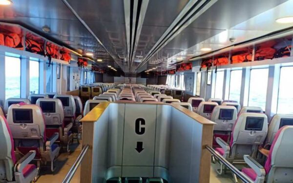 Interior of a train car featuring numerous seats, designed for passenger comfort during the ferry to Ao Nang