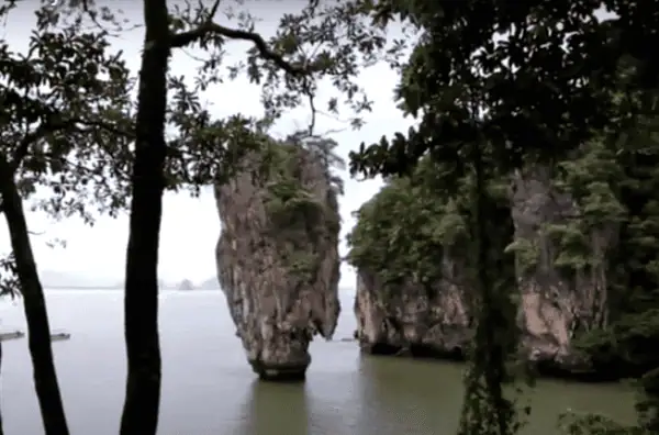 Dramatic limestone rock of James Bond Island rising from turquoise waters in Phang Nga Bay.