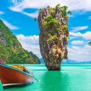 Colorful longtail boat in front of James Bond Island's iconic limestone cliffs