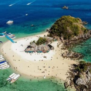 Picturesque island with boats and visitors enjoying serene clear waters during a Khai Island day trip tour.