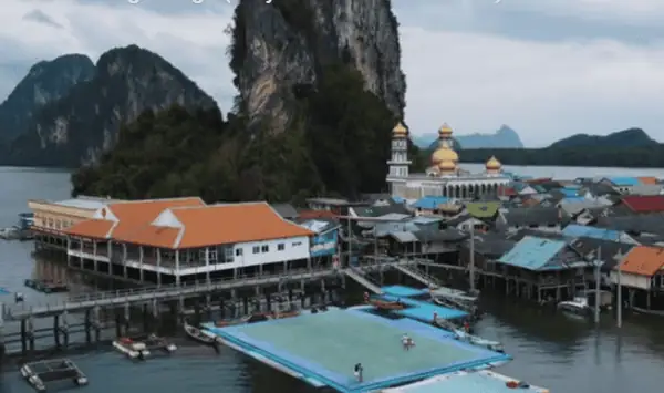 Stilt houses of Koh Panyee floating above the water in Phang Nga Bay.