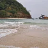 The tides expose a sandbank off a small island.