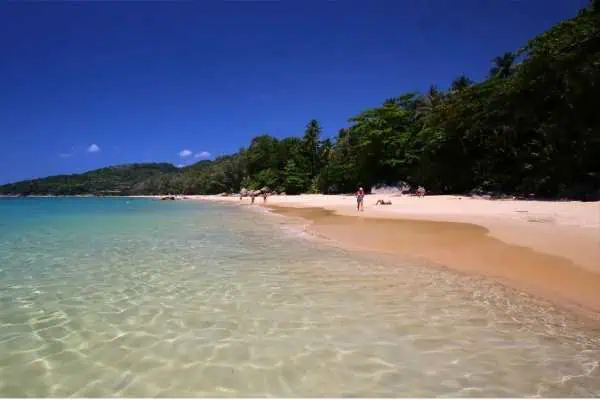 Nai Thon Beach with white sand and clear water, ideal for swimming and snorkeling.