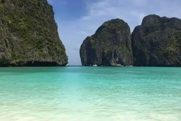 Breathtaking Maya Bay in Thailand, famous for its vibrant waters and stunning beach surrounded by towering cliffs.