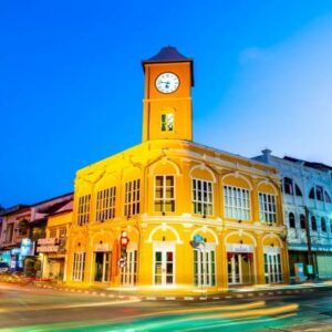 A historic clock tower stands tall in the old town, showcasing its architectural beauty against a clear blue sky.