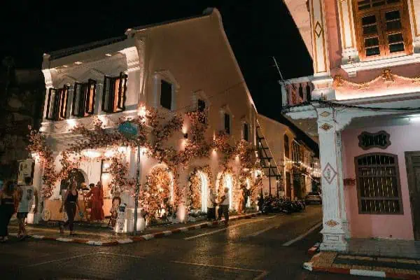 Illuminated Soi Romani Street in Phuket City at night, showcasing vibrant lights, bustling nightlife, and lively atmosphere.