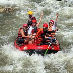 A group of individuals navigating a river in an inflatable raft, enjoying an adventurous outdoor experience.