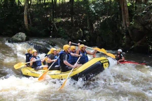 Adventurers navigate a rafting experience through the lively waters of Phang Nga, showcasing the thrill of outdoor exploration near Phuket.