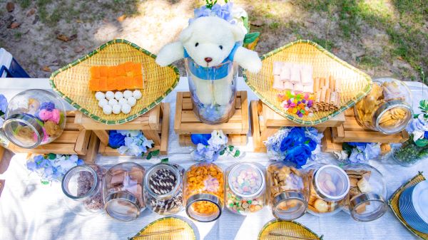 A charming table adorned with an array of food items and a delightful teddy bear, evoking a sense of comfort and joy.