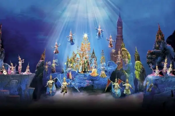 The cast of traditional Thai Siam-Niramit-Show-Phuket, dressed in vibrant costumes, performing on stage with intricate designs and colorful details.