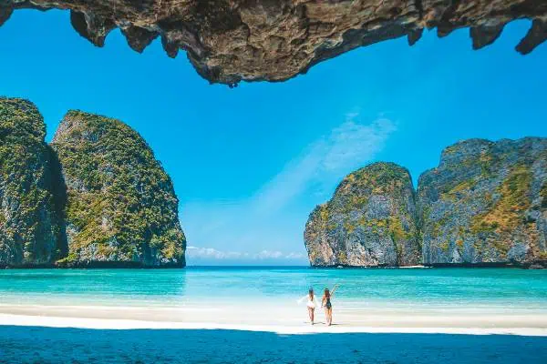 A stunning view of Thailand's pristine beaches, showcasing crystal-clear waters and soft white sands under a bright blue sky.