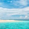 A serene island at Phuket, showcasing lush greenery and clear blue waters, perfect for relaxation and exploration.