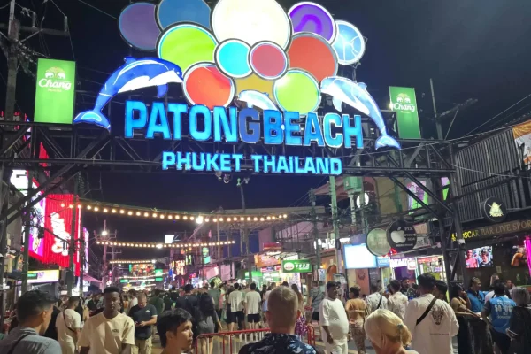 Entrance to Bangla Road from Beach Road with neon lights and lively bars at night.