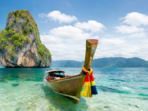 Traditional longtail boat in clear water Phuket Thailand