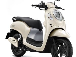 A Honda Scoopy scooter in white is displayed against a clean white background, emphasizing its sleek design.