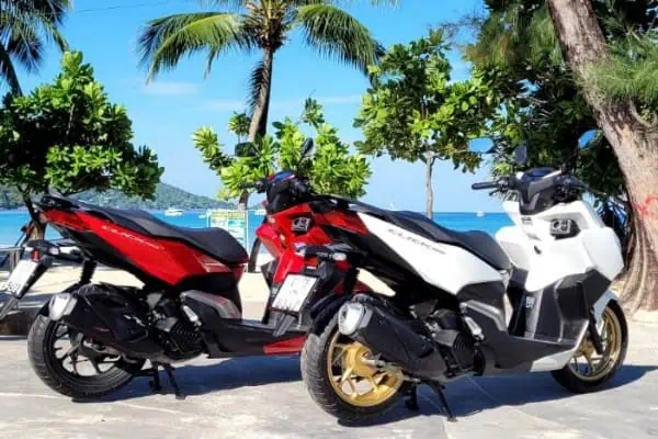 Three motorcycles arranged in different orientations, showcasing their unique designs and functionalities for scooter rental.