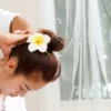 Woman receiving relaxing Thai massage with herbal oil in a Phuket spa.