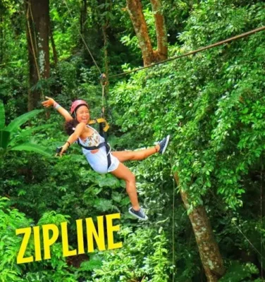 A woman glides on a zip line in Phuket, with the word "absolut" prominently displayed in the image.